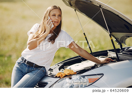 Woman near broken car call for help Woman near broken car call for help 64520609