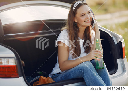 Elegant woman sitting in a trunk with water 64520659
