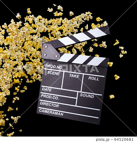 Flying popcorn and film clapper board isolated on black background 64520681