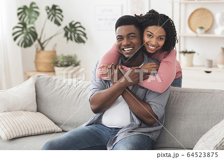 Happy Married Black Couple Cuddling At Home And Posing To Camera 64523875