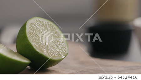 lime cut in half on wood board 64524416