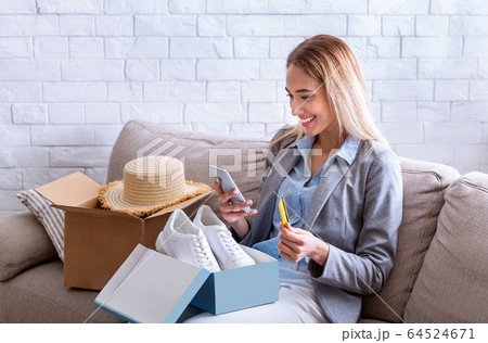 Happy girl received delivery an online purchase Happy girl received delivery an online purchase 64524671