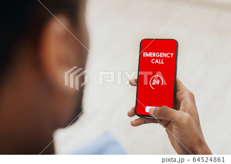 Black man holding smart phone with emergency number Black man holding smart phone with emergency number 64524861