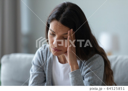 Unhappy thoughtful woman touching face, thinking about problems 64525851