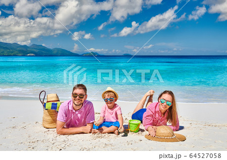 Family with three year old boy on beach. Family with three year old boy on beach. 64527058