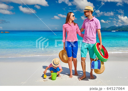 Family with three year old boy on beach. 64527064