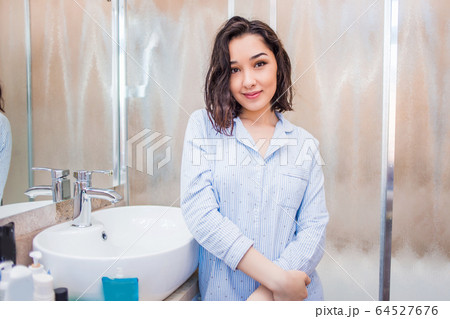 Young smiling woman in the bathroom Young smiling woman in the bathroom 64527676