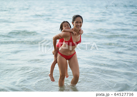 Asian chinese woman spending time playing with 64527736