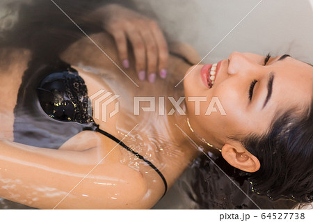 Close up portrait of a young happy woman relaxing 64527738
