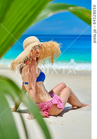 Woman on beach at Seychelles Woman on beach at Seychelles 64528050