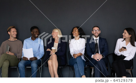 Overjoyed diverse job candidates have fun talking before interview 64529379