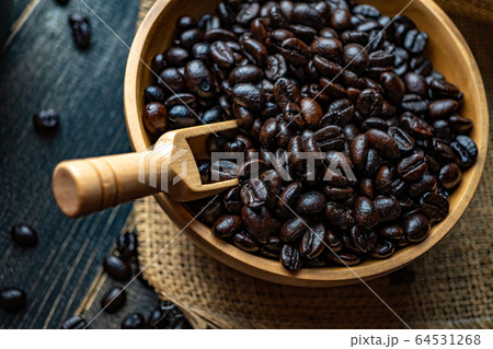 Closeup Fresh Coffee beans in wooden bowl on a bag 64531268