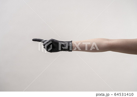 Hands in black silicone gloves on a light background. Hands in black silicone gloves on a light background. 64531410