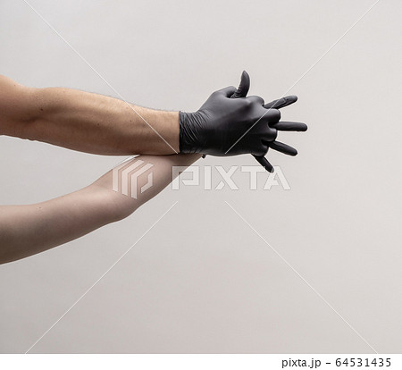Male and female hand in black gloves. Hold each other. Male and female hand in black gloves. Hold each other. 64531435