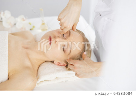 Beautiful caucasian woman getting face depilation procedure. Beauty and Spa salon concept 64533084