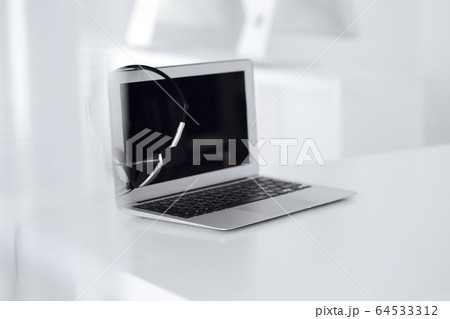 Call center and communication support, customer service help desk. VOIP headset on laptop computer 64533312