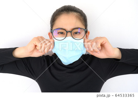 Shot of young Asian woman worring and wearing mask for protect bad air pollution or virus. 64533365