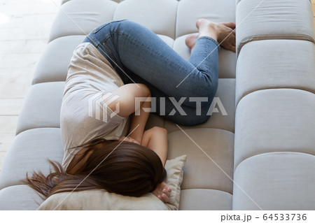 Tired after sleepless night young woman lying and resting. 64533736