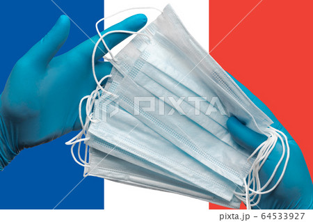 Doctor holds face masks in hands blue gloves on background national flag of France. Concept quarantine, hygiene, pandemic outbreak. Surgical antibacterial face bandage Doctor holds face masks in hands blue gloves on background national flag of France. Concept quarantine, hygiene, pandemic outbreak. Surgical antibacterial face bandage 64533927