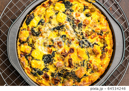 Top view of delicious freshly baked homemade quiche on a wooden table. Top view of delicious freshly baked homemade quiche on a wooden table. 64534246