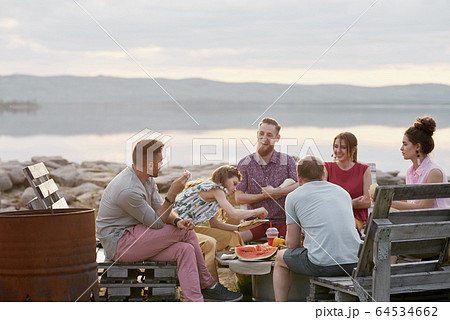 Friends Spending Evening Outdoors Friends Spending Evening Outdoors 64534662