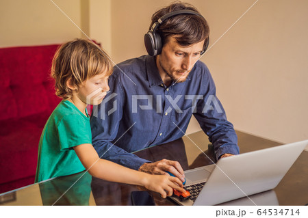 Man is trying to work from home because of the coronovirus epidemic, but his son is stopping him Man is trying to work from home because of the coronovirus epidemic, but his son is stopping him 64534714