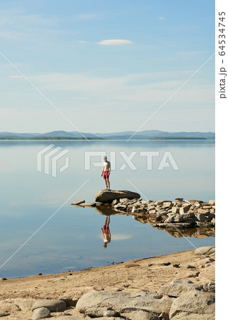 Man Spending Summer Day On Lake Man Spending Summer Day On Lake 64534745