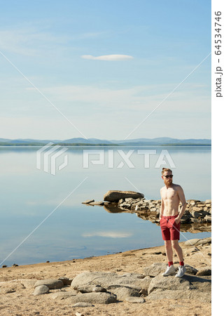 Shirtless Man On Lake Beach 64534746