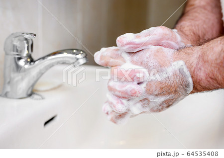 Close up of Senior man washing his hands using soap foam, Prevention from covid19, Coronavirus or 64535408