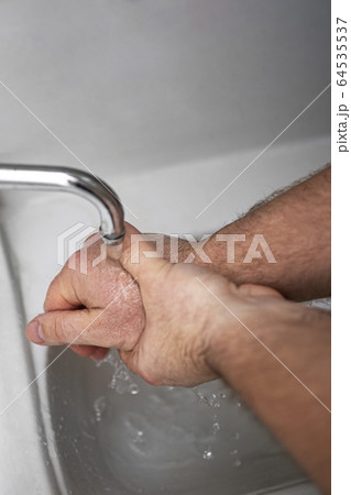 Men's hands are showing ways to wash their hands with a cleaning gel to prevent infectious diseases 64535537