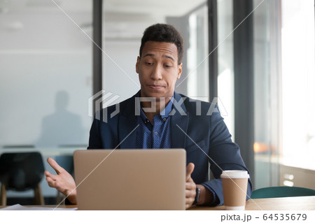 Stressed annoyed african black business man using stuck slow laptop 64535679