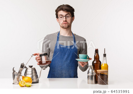 Barista, cafe worker and bartender concept. Portrait of indecisive careless young bored male employee grimacing look away uncertain, hold kettle with filter coffee and cup, white background Barista, cafe worker and bartender concept. Portrait of indecisive careless young bored male employee grimacing look away uncertain, hold kettle with filter coffee and cup, white background 64535991