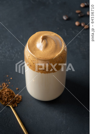 Dalgona coffee in glass on black. Korean drink 64536710