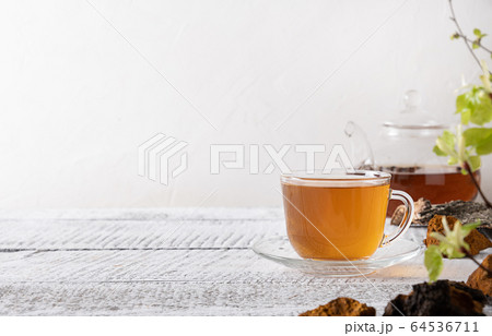 Chaga mushrooms infusion in glass cup.  64536711