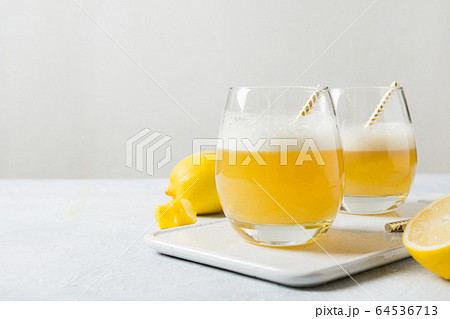 Two whiskey sour cocktails with ingredients, lemon 64536713