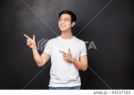 Handsome young healthy asian guy in white shirt contemplate something pleasant, smiling and looking upper left corner happy, see good offer, great opportunity, advertisement concept Handsome young healthy asian guy in white shirt contemplate something pleasant, smiling and looking upper left corner happy, see good offer, great opportunity, advertisement concept 64537103