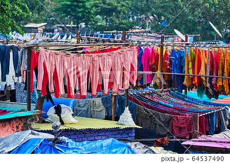 Dhobi Ghat is an open air laundromat lavoir in Mumbai, India with laundry drying on ropes 64537490