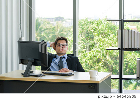 Businessmen rest his eyes after completing work. Businessmen rest his eyes after completing work. 64545809