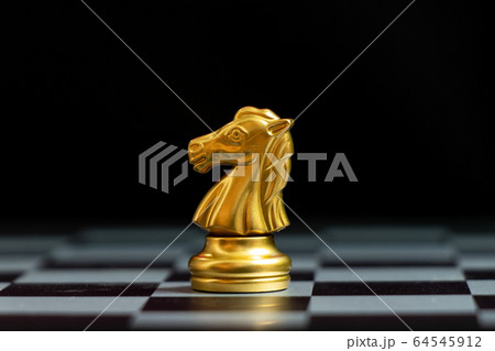 Gold knightchess piece stand on black background 64545912