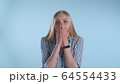 Blonde female widely opening her mouth in astonishment 64554433