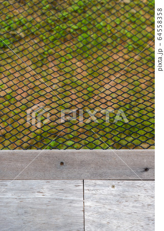 black color hammock net near wooden floor. texture 64558358