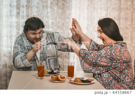 Plus Size Woman Feeding Her Husband Healthy Food 64558667