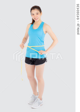 Beautiful slim young asian woman measuring tape thin waist wear uniform fitness isolated Beautiful slim young asian woman measuring tape thin waist wear uniform fitness isolated 64560436