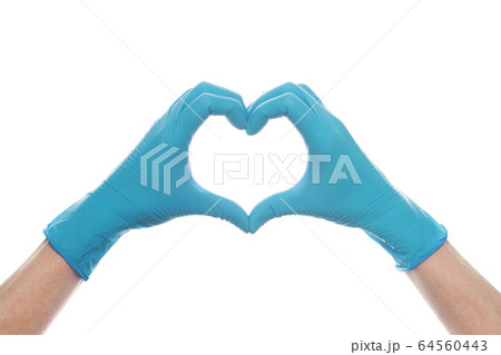 Hand in medical gloves showing heart isolated Hand in medical gloves showing heart isolated 64560443