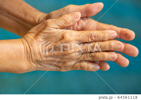 Senior woman's hands washing her hands in step 1 on bokeh blue pool  background, Close up & Macro shot, Selective focus, Prevention from covid19, Bacteria, healthcare concept, 7 step wash hand Senior woman's hands washing her hands in step 1 on bokeh blue pool  background, Close up & Macro shot, Selective focus, Prevention from covid19, Bacteria, healthcare concept, 7 step wash hand 64561118