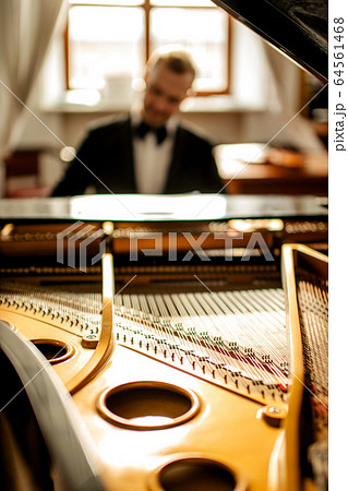 male performing music with the use of piano male performing music with the use of piano 64561468