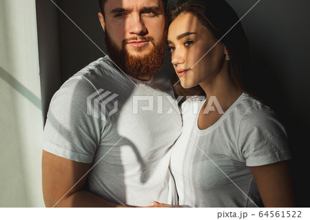 portrait of romantic caucasian couple looking at window 64561522