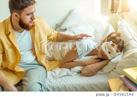 young caucasian man strike his girlfriend while she is sleeping young caucasian man strike his girlfriend while she is sleeping 64561544