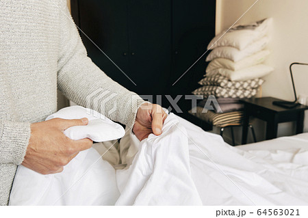 caucasian man making the bed caucasian man making the bed 64563021