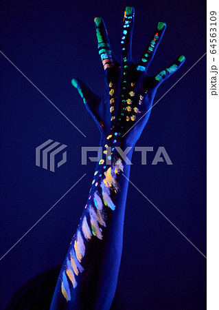 cropped photo of male hands with fluorescent paint 64563109